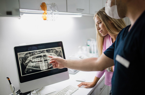 Dentist and assistant reviewing a digital xray at Karl Hoffman Dentistry in Lacey, WA